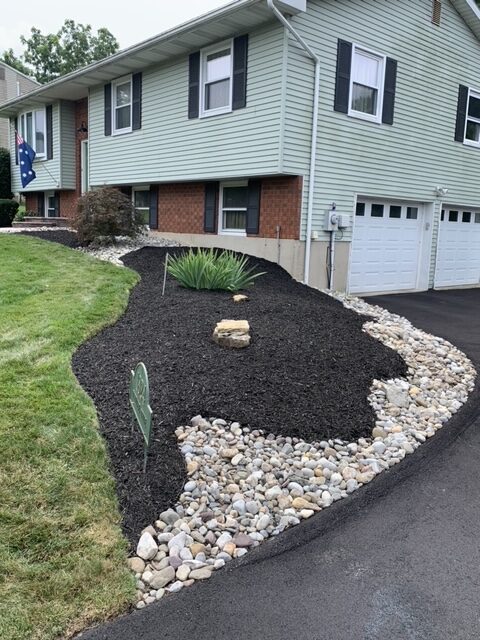 River rock and mulch used in garden design.